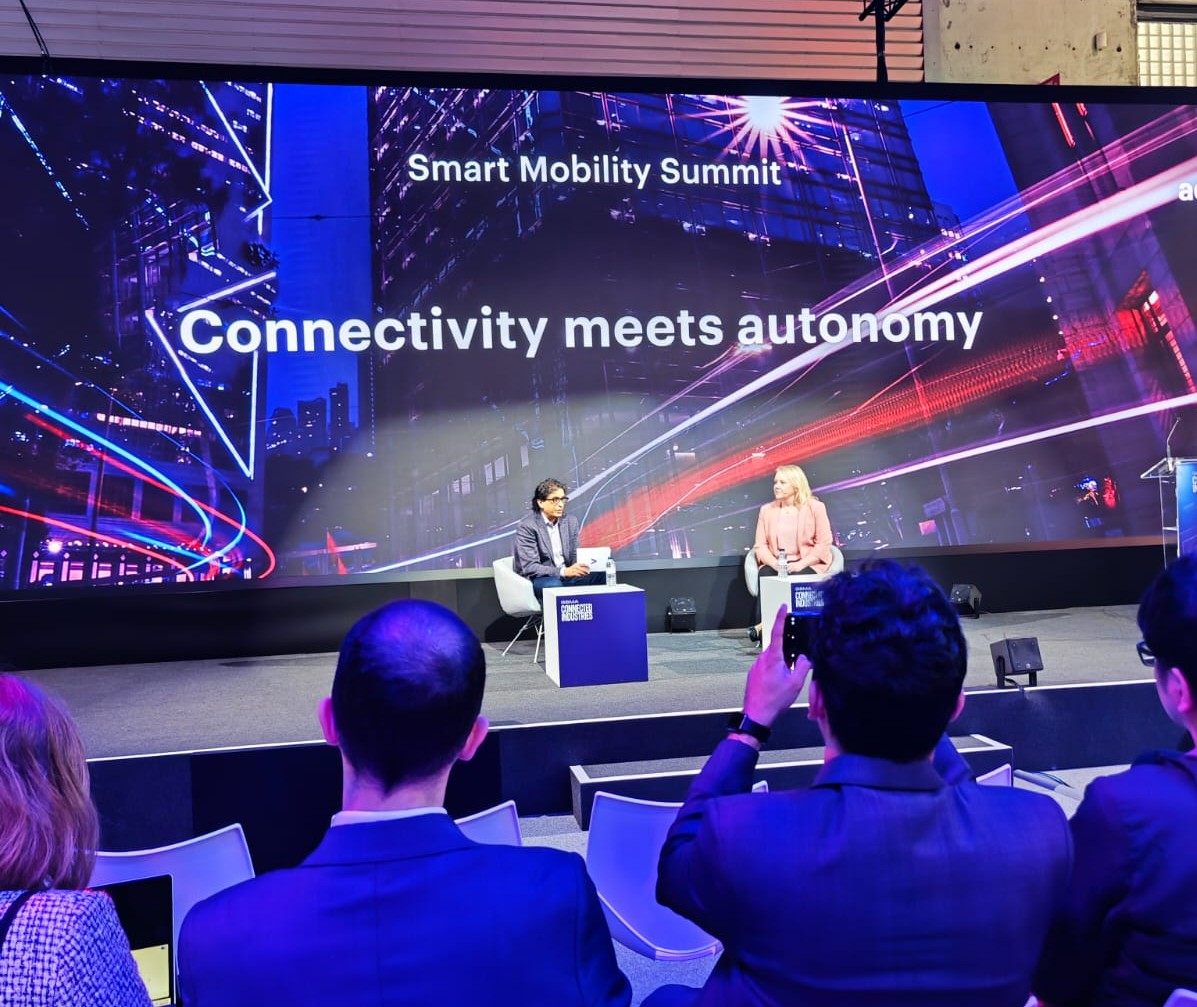Speakers presenting on stage during the Smart Mobility Summit at Mobile World Congress Barcelona 2026, discussing the future of connected and software-defined mobility.